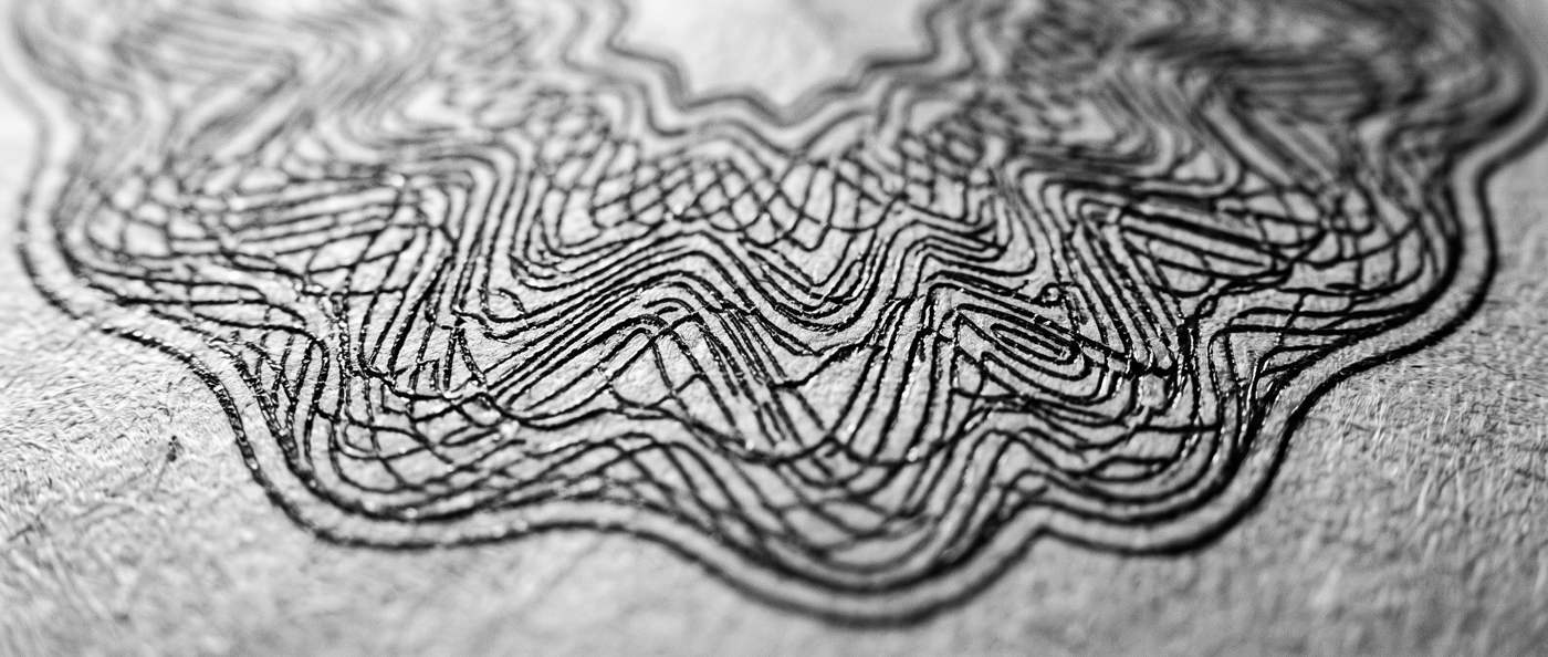 Engraved guilloché lines on banknote paper, close up
