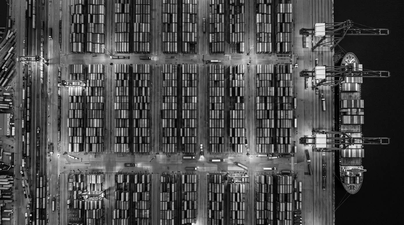 A container port from above, stacks of containers in a grid